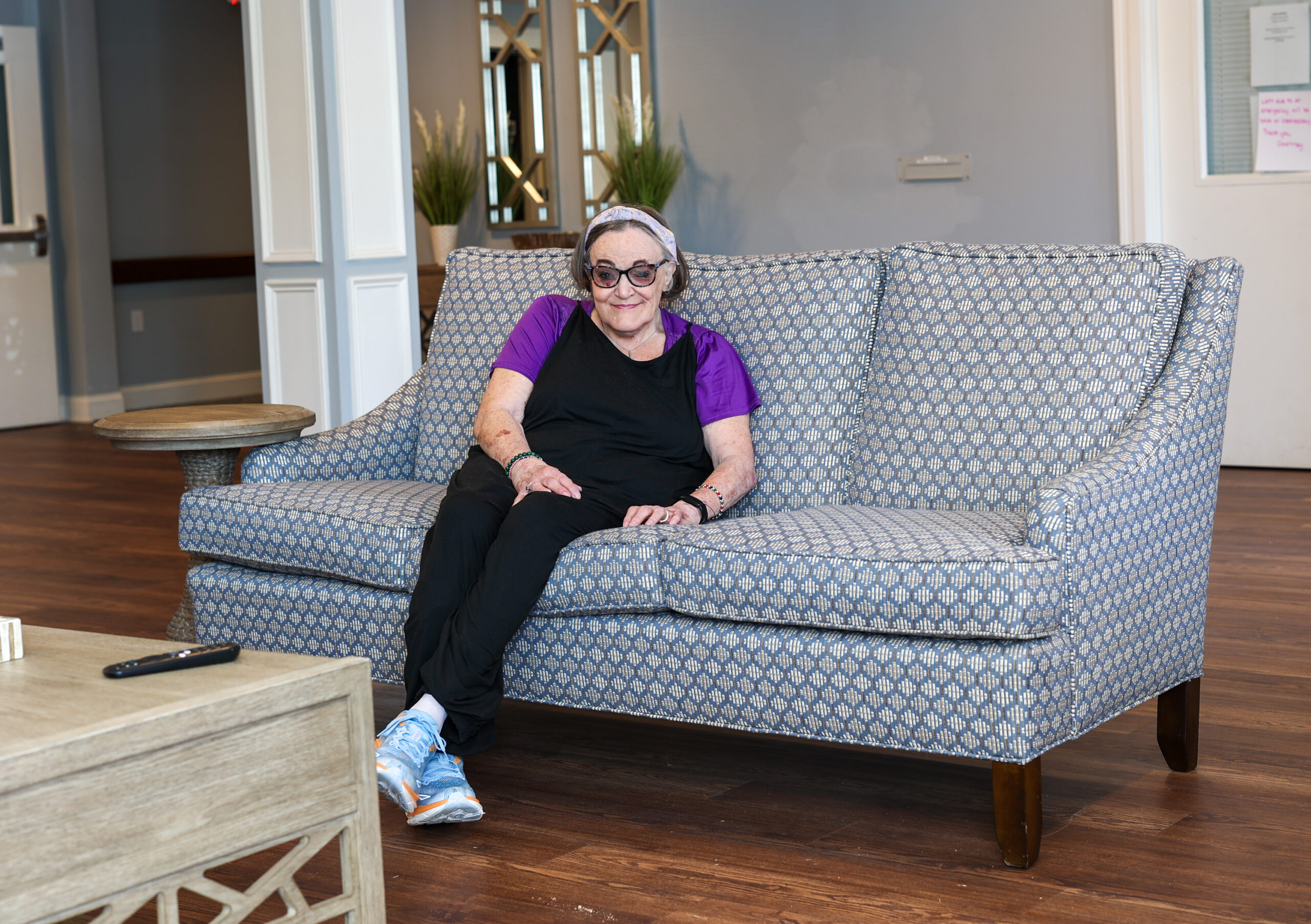 Above, Wanda Tiller relaxes in the lobby of her new apartment home; at top, Wanda visits with Kirby Morrow, her advocate at Disability Rights NC.