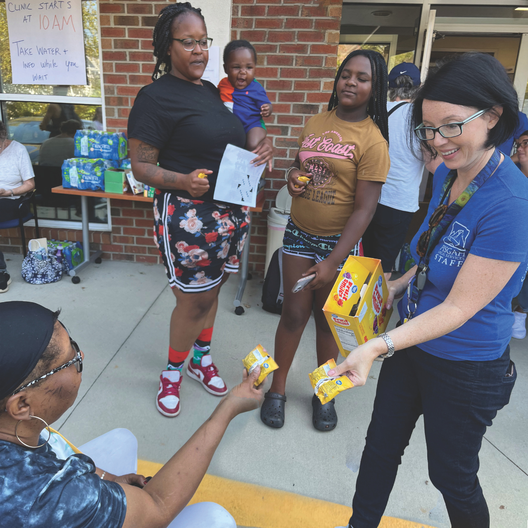 Disaster Relief 1 Kiger provides snacks to individuals waiting for assistance at a FEMA clinic hosted at the organization’s Asheville office on Oct. 7.